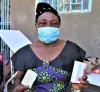 Suzanne Mawazao holds up contraceptive pills from her CBD toolkit. Photo Credit: Landry Malaba, Abt Global for USAID IHP